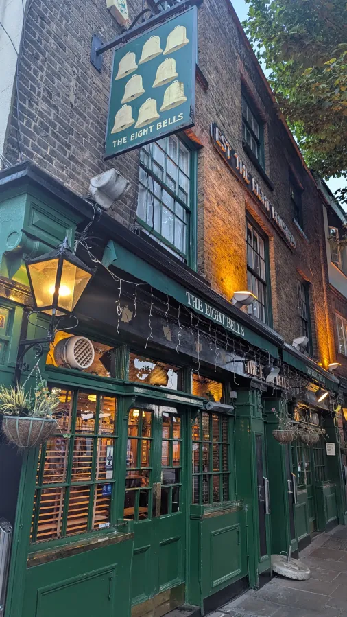 The green frontage and bell sign outside The Eight Bells, Fulham