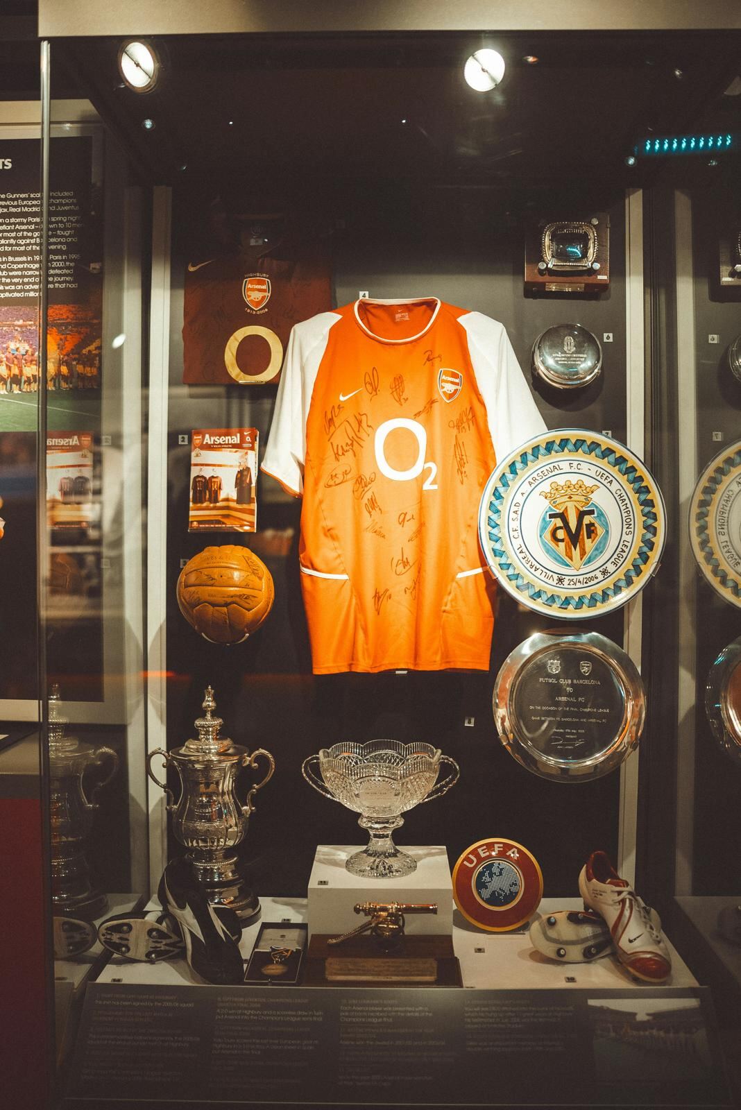 Arsenal trophy case with signed shirts and silverware